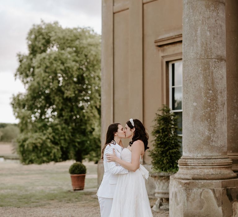 The brides share a kiss at the Wilderness Reserve wedding venue 