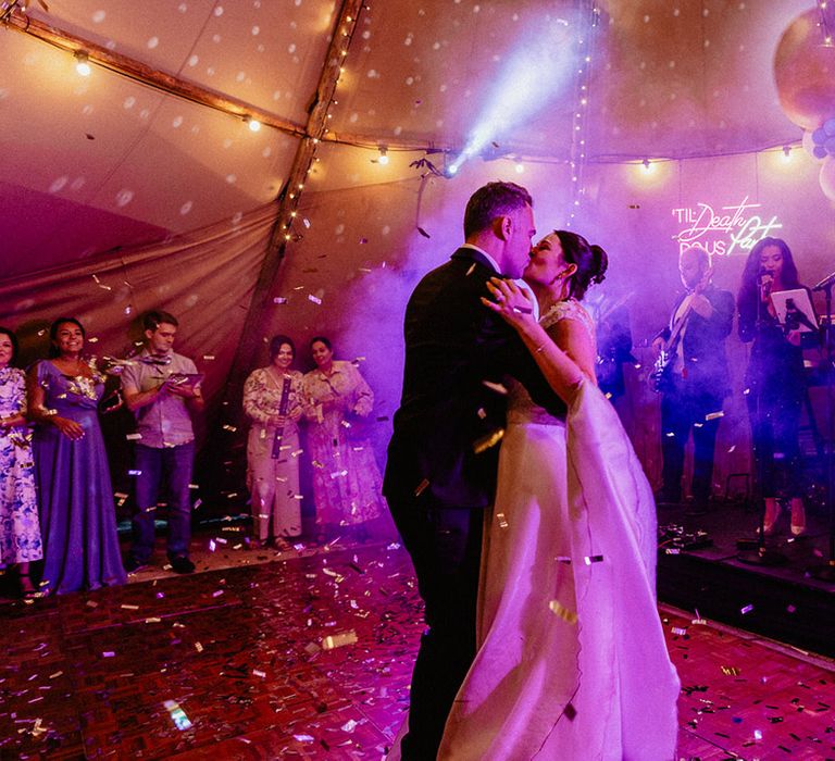 Neon wedding light with epic ballon decoration in the tipi as the bride and groom share their first dance together at Culden Faw Estate 