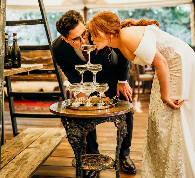 Bride & groom sip from champagne tower at The Dreys wedding reception