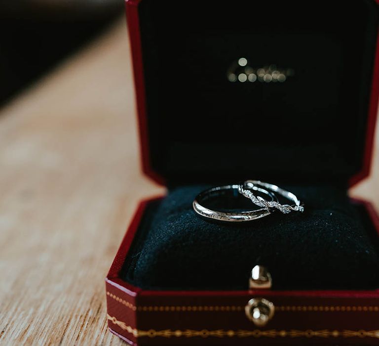 Plain silver wedding band for the groom with the bride's twisted silver wedding ring with diamanté detail 