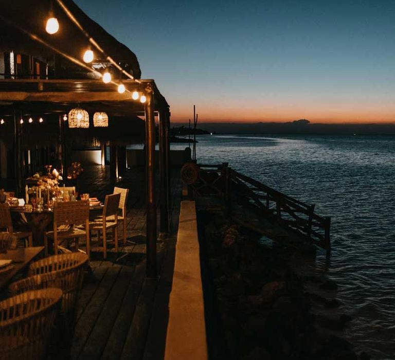 Wide shot of the Mexico beach destination hotel wedding venue at sunset 