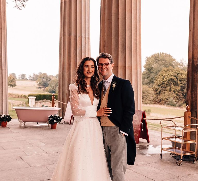 Mansion wedding in Hampshire with the bride in a pearl wedding dress and groom in a morning suit 