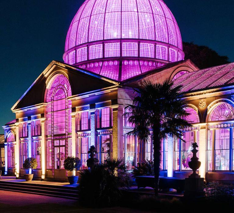 Exterior shot of Syon Park wedding venue with bright lights for 10 year vow renewal ceremony