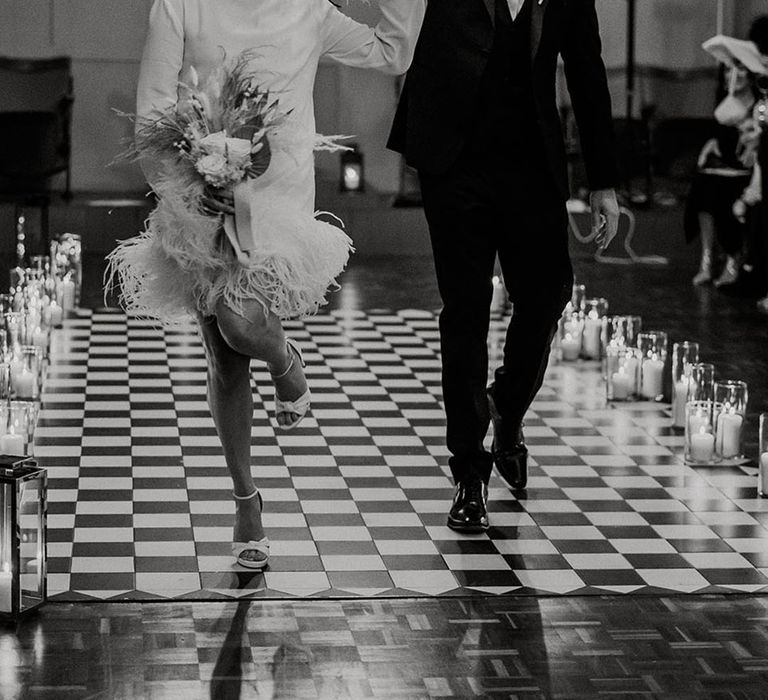 The bride and groom walk back down the aisle as a married couple 