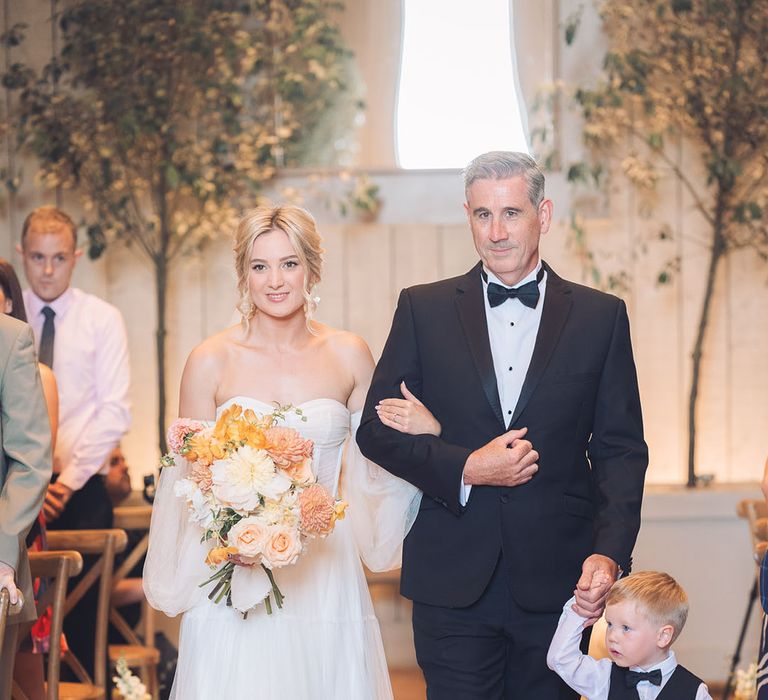 Father of the bride walking his daughter down the aisle 