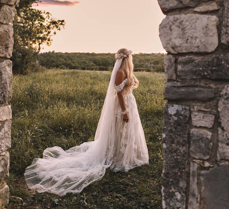 Bride in boho floral wedding dress with flower crown at destination wedding 