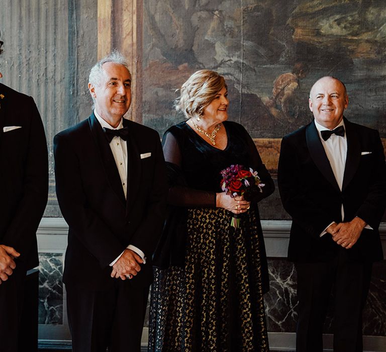 The wedding party wearing all black wedding guest outfits for the ornate gothic wedding at Ca'Sagredo hotel in Venice 