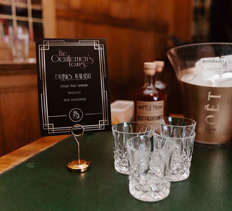 Wedding cocktail and bar area with crystal glassware, buckets of ice and alcohol 