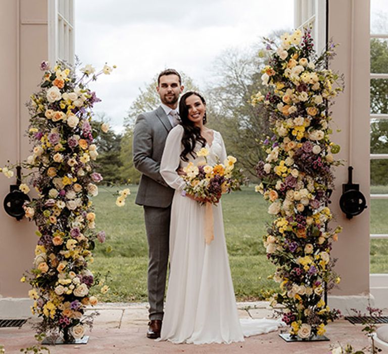 Yellow and purple wedding flower columns. bouquet and aisle flowers for summer wedding 