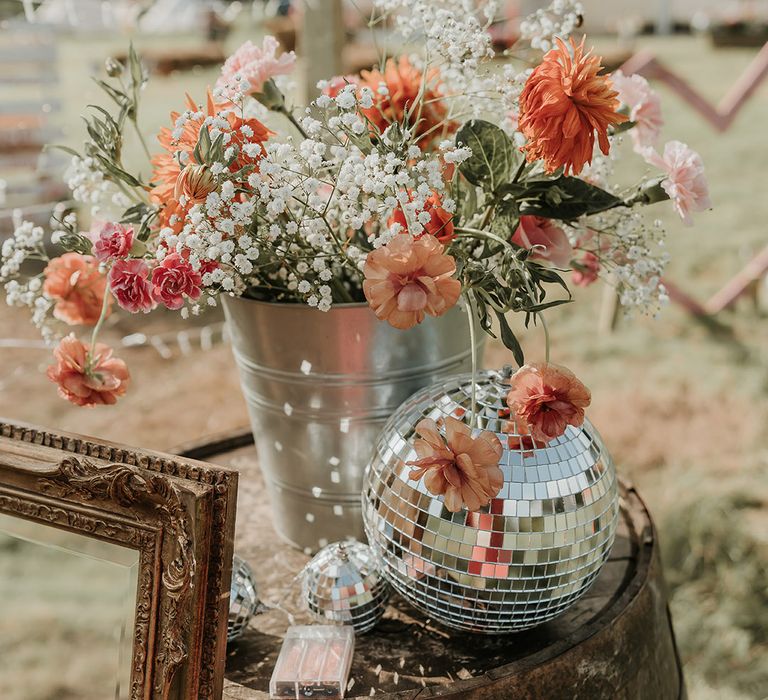 Gypsophila and orange roses with disco balls and fairy lights 