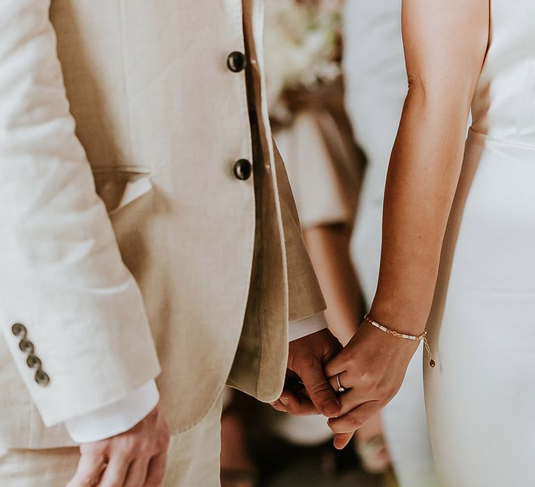 Bride and groom holding hands at their civil wedding ceremony 