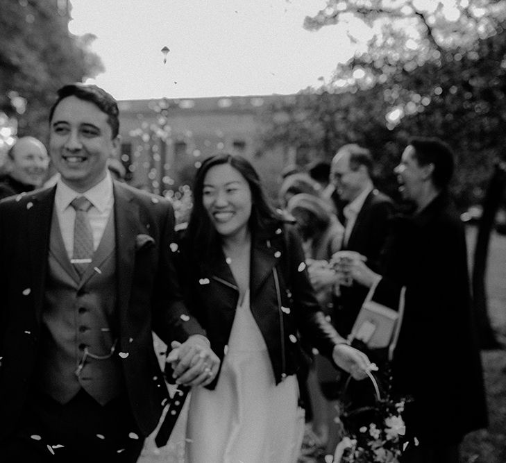 Confetti moment with bride in leather jacket