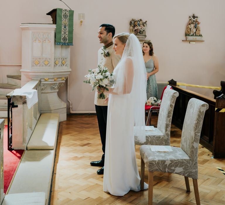 Bride and groom standing at the altar of 2020 wedding 