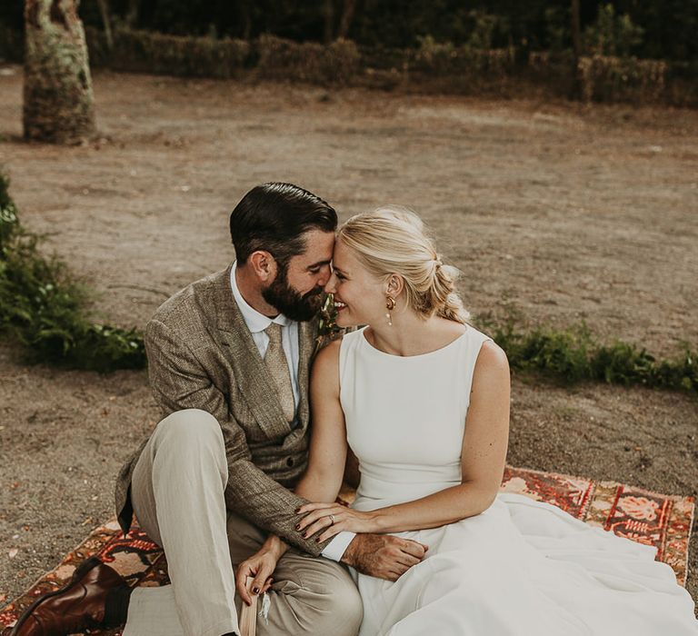 Bride and groom portrait sitting on a Persian rug