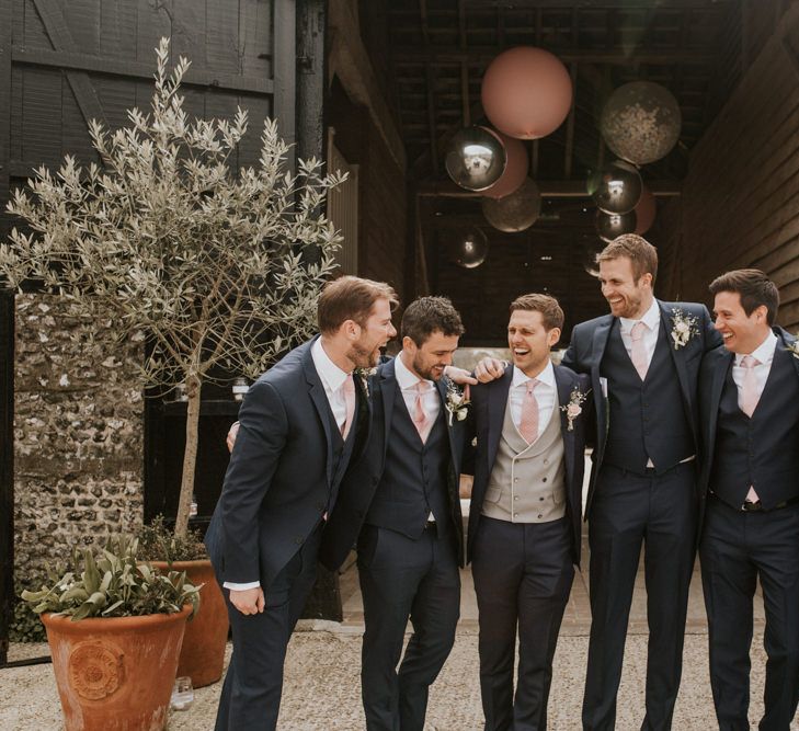 Groomsmen in Navy suits with pink ties 