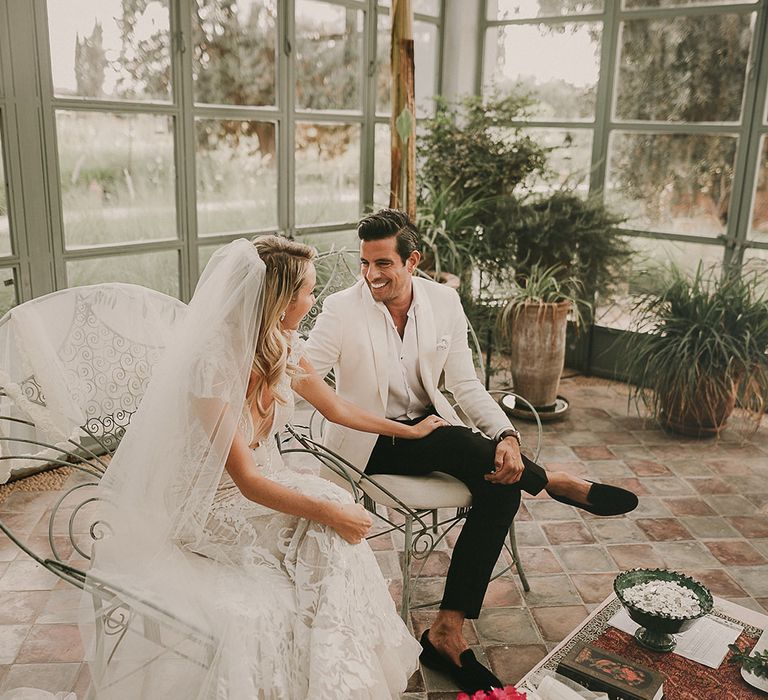 Bride and groom smiling at each other at Marrakech wedding ceremony 