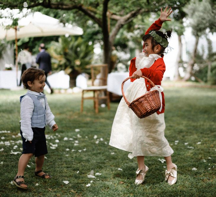 Flower girl playing with flower petals 