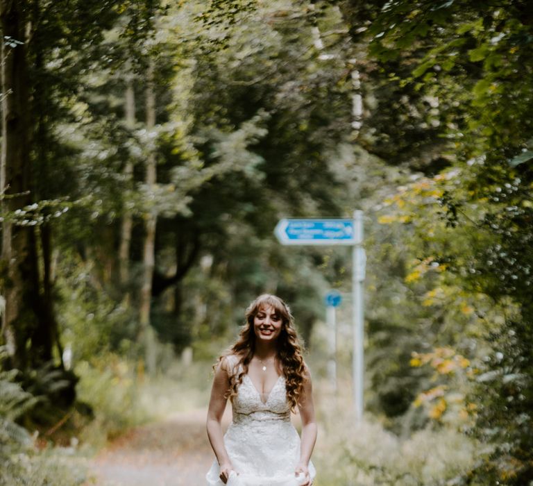 Bride wears sparkly floral wedding dress with deep cut and insert and matching tartan patterned flat shoes