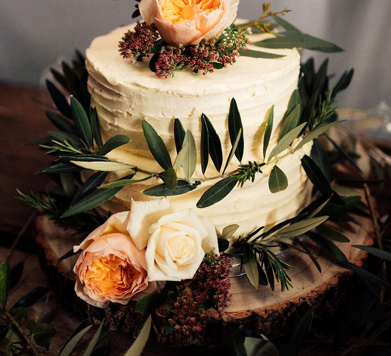 Cream wedding cake with foliage and Mr & Mrs sign