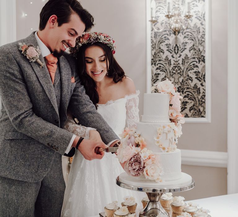 Bride and groom cut two tier wedding cake