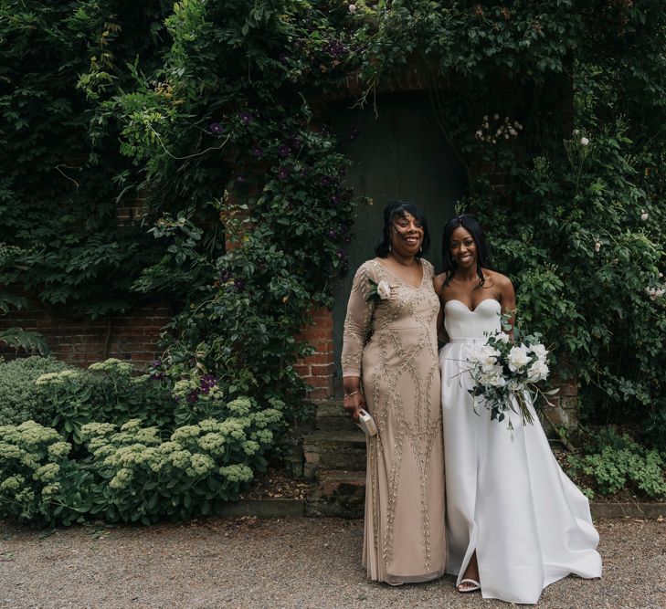 Bride in strapless wedding dress and mother of the bride in an embellished dress