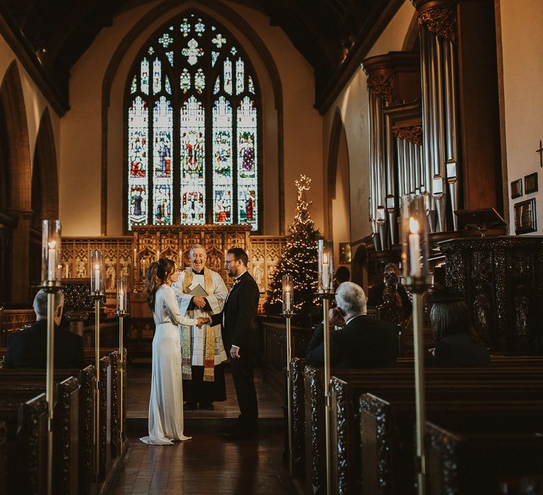 Bride & groom during wedding ceremony at Sherborne School