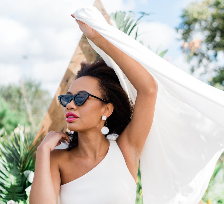 Bride in sunglasses, Maddox wedding dress and Muted Luxe handmade earrings