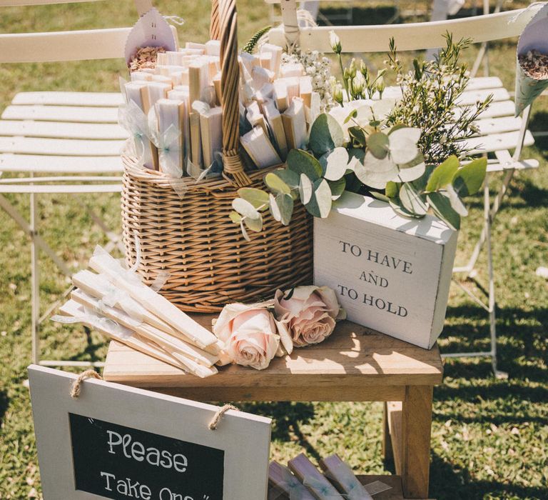 Guests were offered fans for the outdoor wedding ceremony