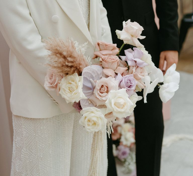 Pastel pink and purple wedding bouquet with rose and anthurium flowers 