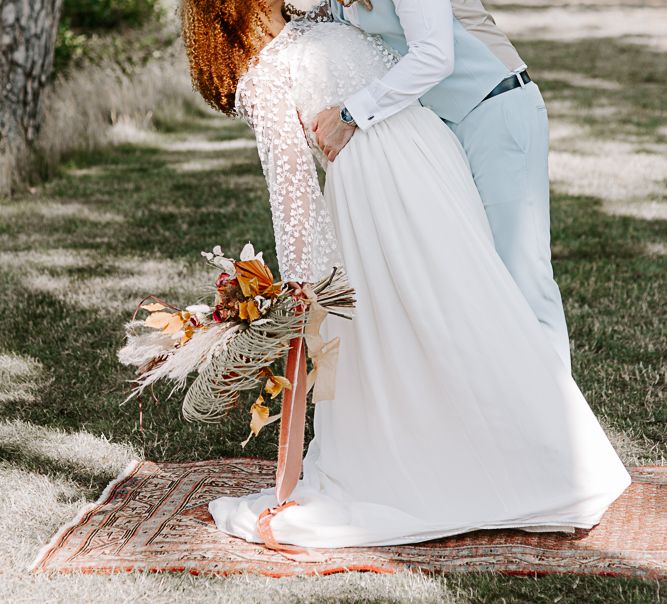 Groom kisses bride on their wedding day 