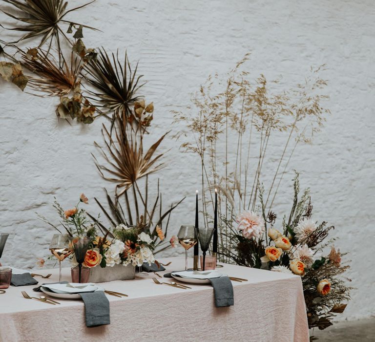 Minimal and stylish tablescape with linens and velvet detailing for a contemporary wedding