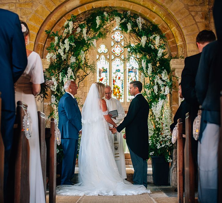 Bride and groom saying vows at church countryside wedding