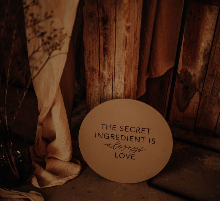 'The secret ingredient is always love' circular wedding sign 