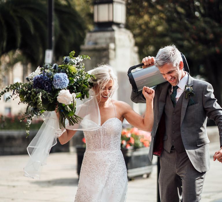 Bride & groom walk through London in the sunshine