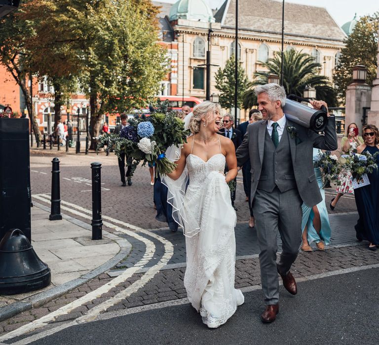 Bride & groom walk through the streets of London after wedding ceremony