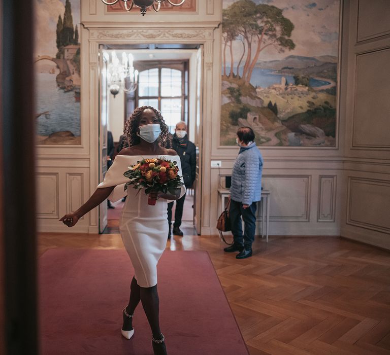 Bride walks into the wedding ceremony carrying bouquet