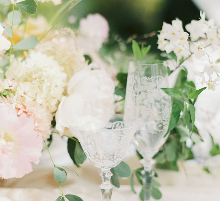 Crystal glassware embossed with floral pattern at a romantic English garden party wedding