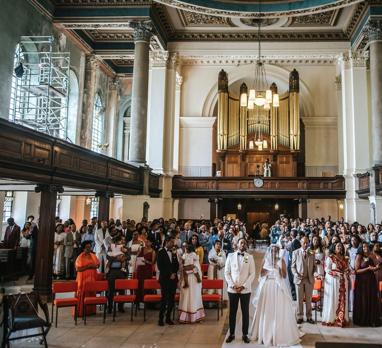 Bride and groom and their congregation at their Church wedding ceremony 