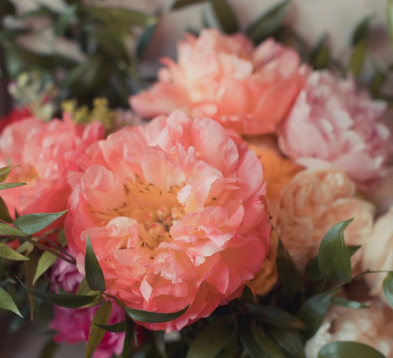 Brightly coloured peonies for brides fresh floral bouquet with green foliage