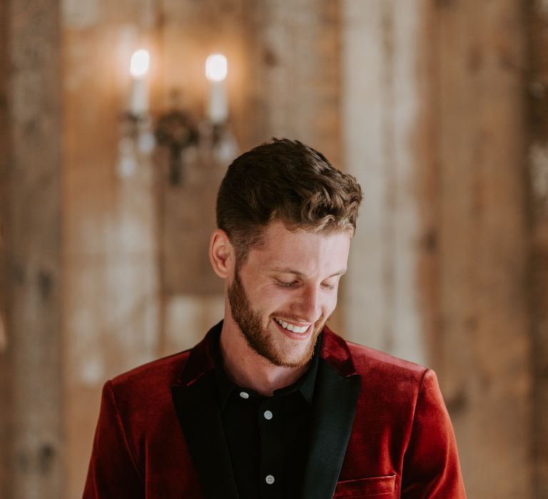 Groom in a red velvet tuxedo jacket with black satin lapels 