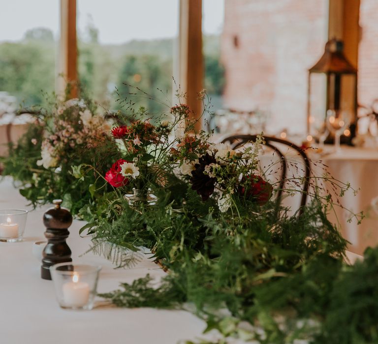 Green foliage, red and white flower table runner 