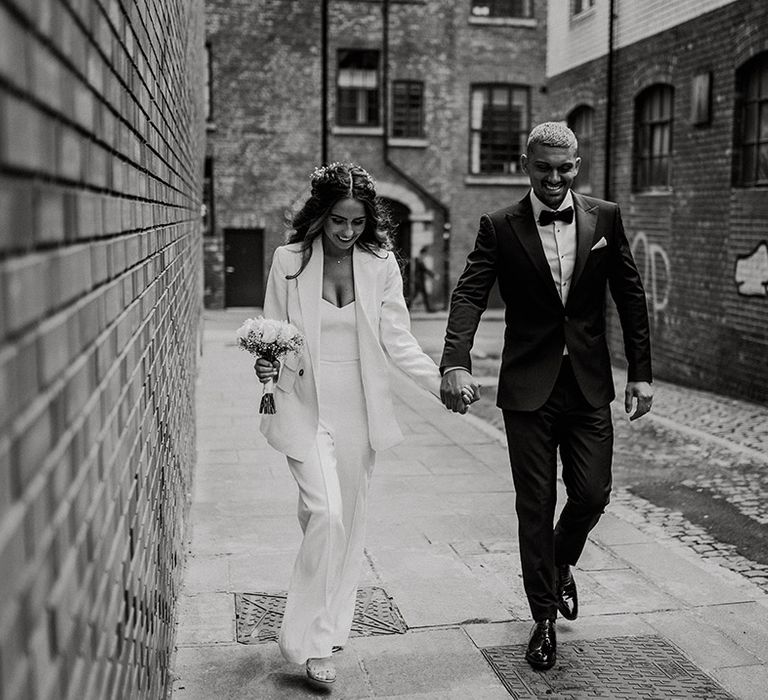 Black and white bride and groom urban portrait around Sheffield with bride in a three-piece suit and groom in a tuxedo 