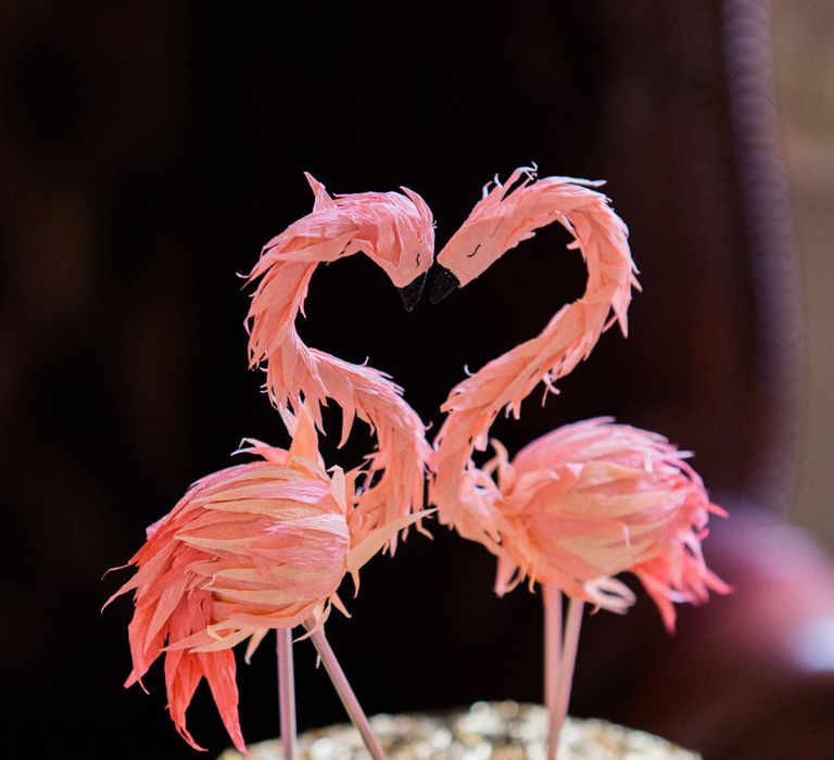 Gold leaf wedding cake with pink flamingo cake toppers 