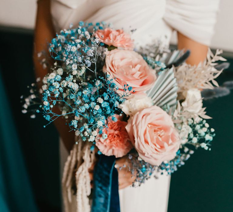 pink and teal wedding bouquet tied with ribbon including gypsophila and roses 