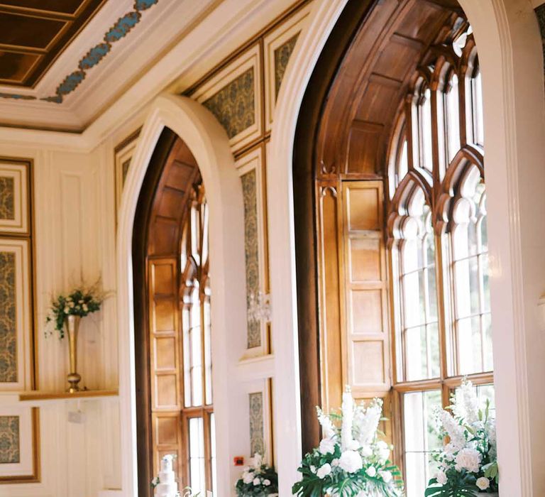 Top table at Drumtochty Castle reception with white and green wedding flowers 