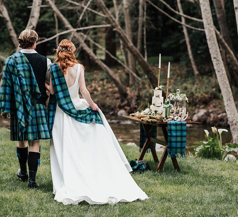 Bride and groom at their outdoor elopement with blue and green wedding tartan kilt and shawl 