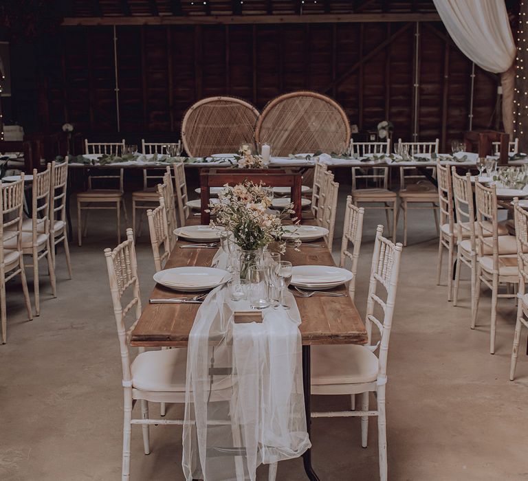 Wooden tables complete with rustic vibe and pale florals throughout