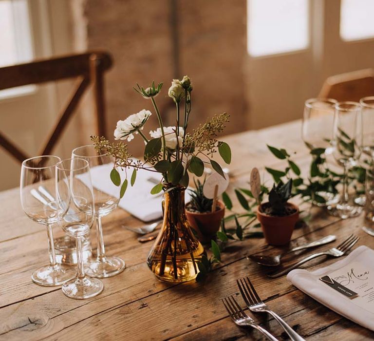 Wedding table place setting with foliage table runner