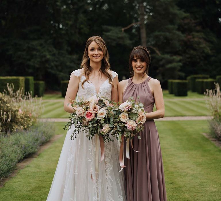 Bride in Madi Lane dress with bridesmaid in dusky purple dress