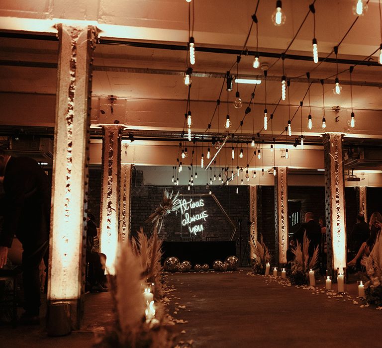 Aisle wedding decor at Victoria Warehouse with industrial lighting, and it was always you neon sign at the altar 